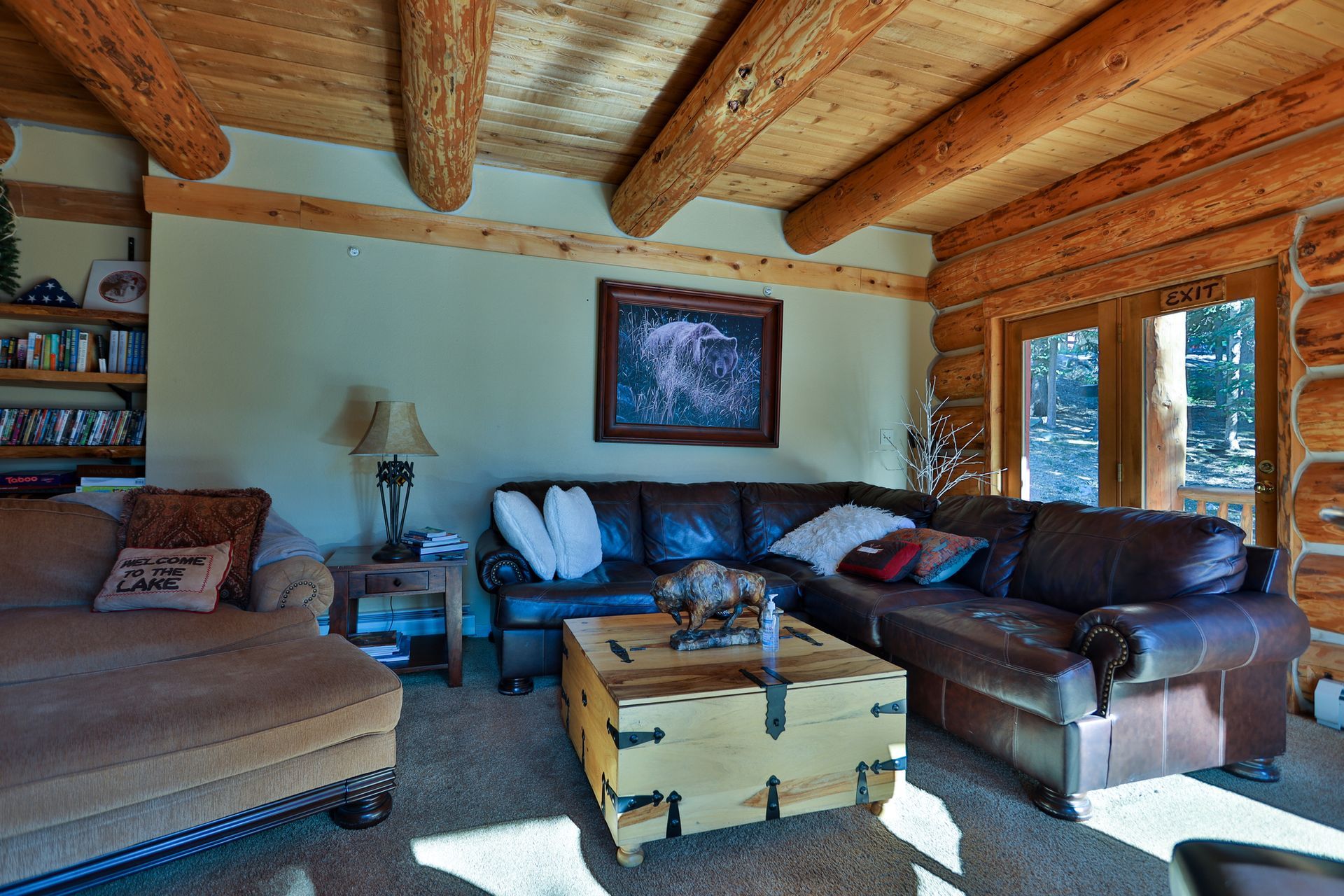 A living room in a log cabin with a couch and a coffee table