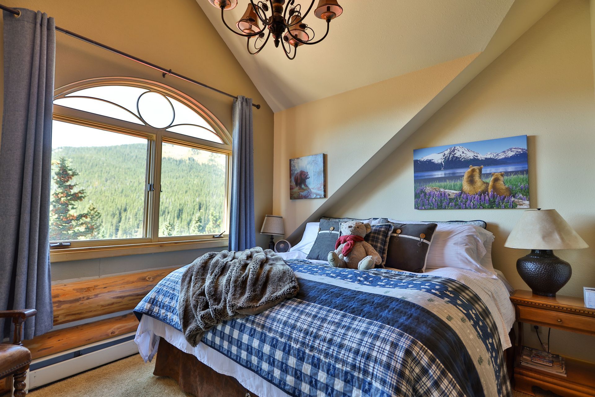 A bedroom with a king size bed and a large window