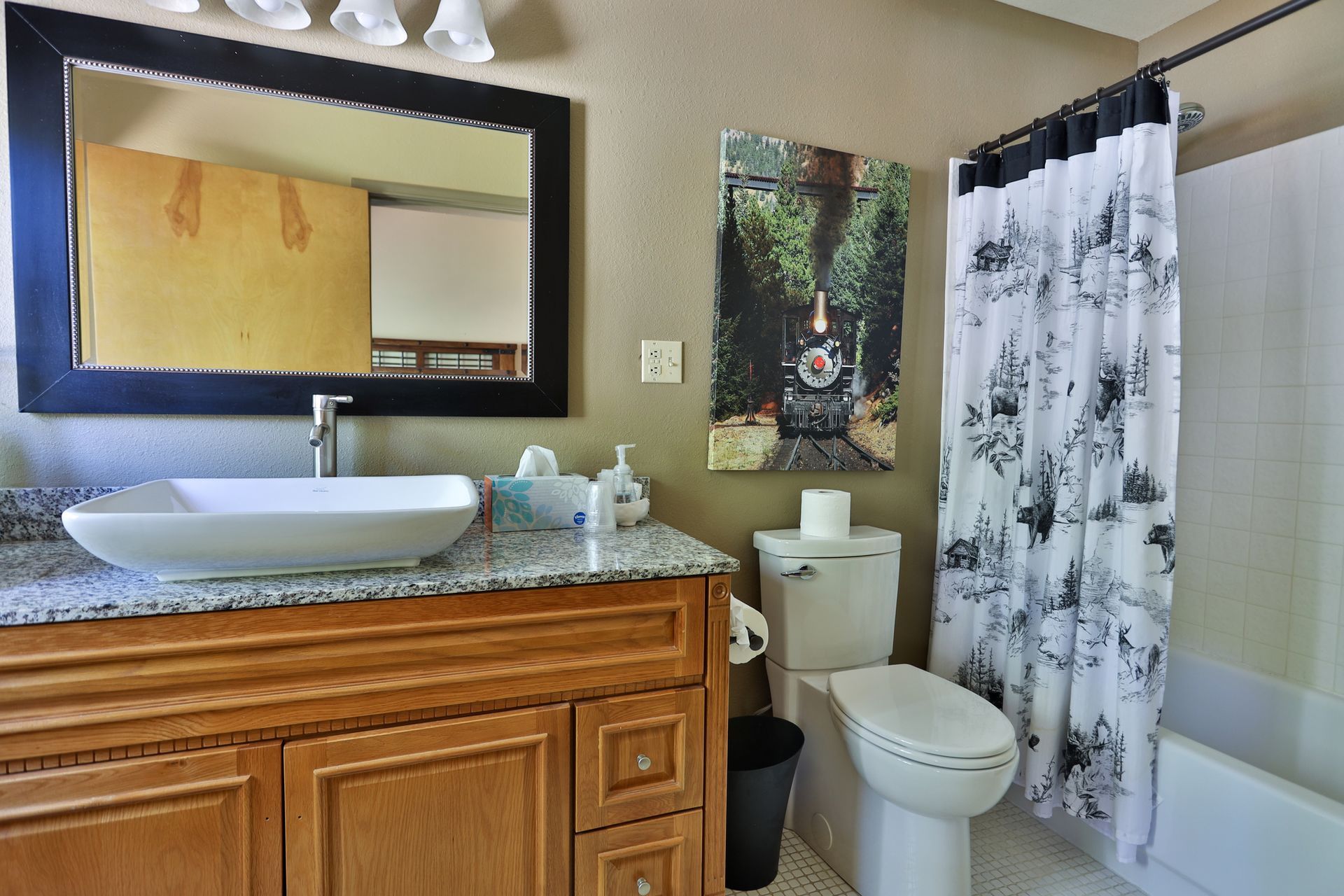 A bathroom with a sink toilet and shower curtain