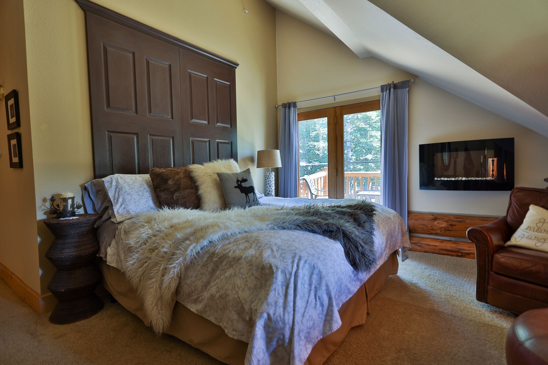 A bedroom with a king size bed and a fireplace