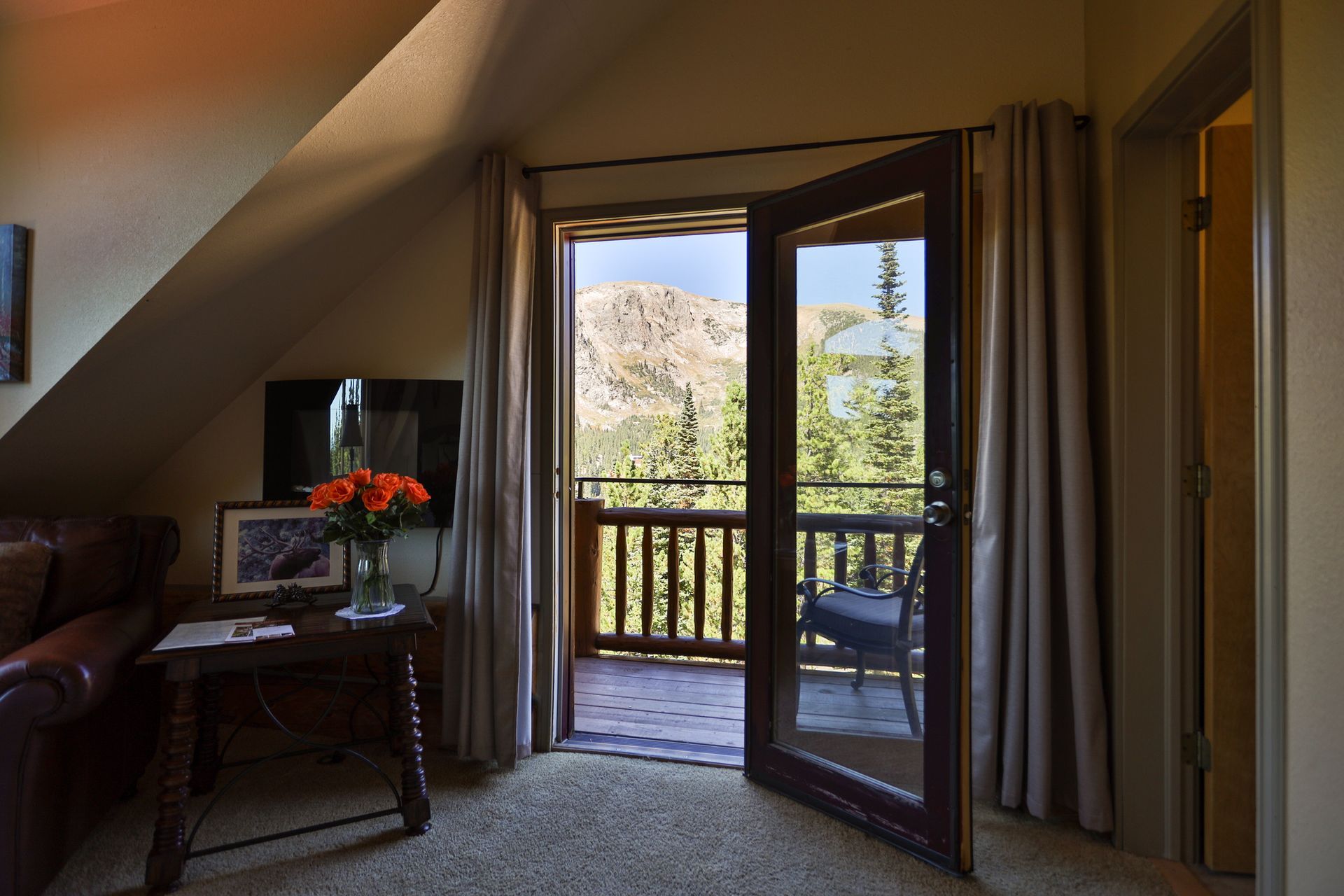 A living room with a sliding glass door leading to a balcony.