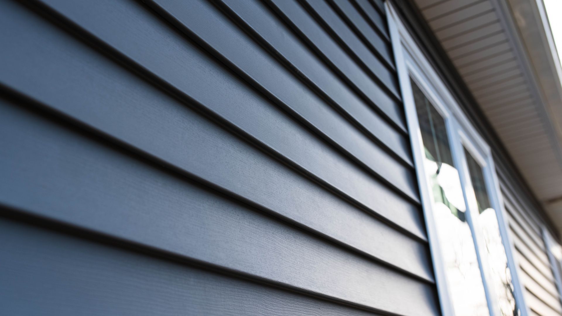 A close up of a blue siding on a house