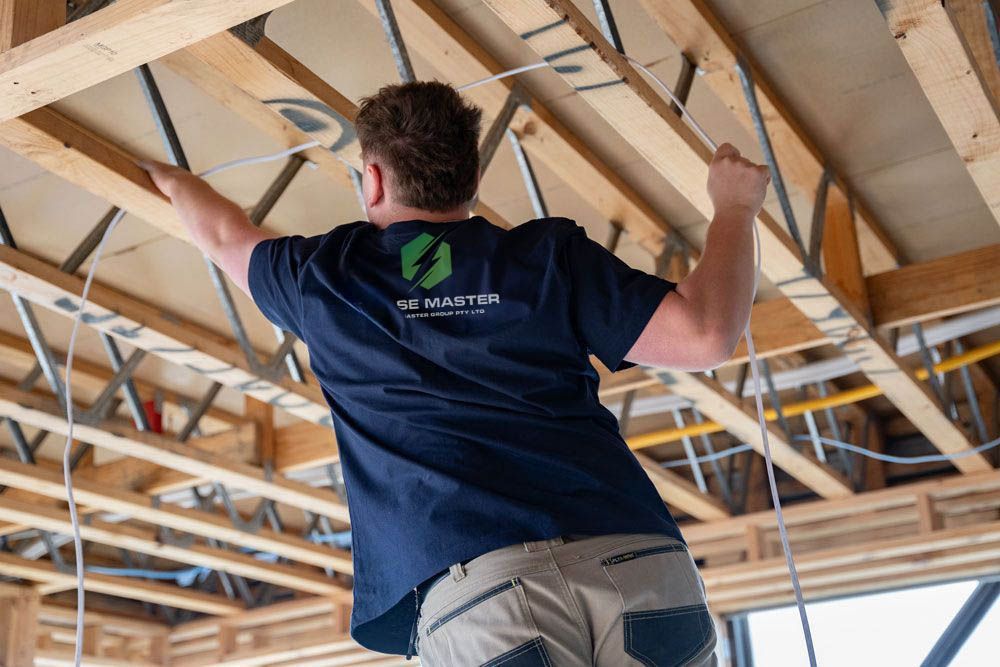 A man is working on the ceiling of a building.