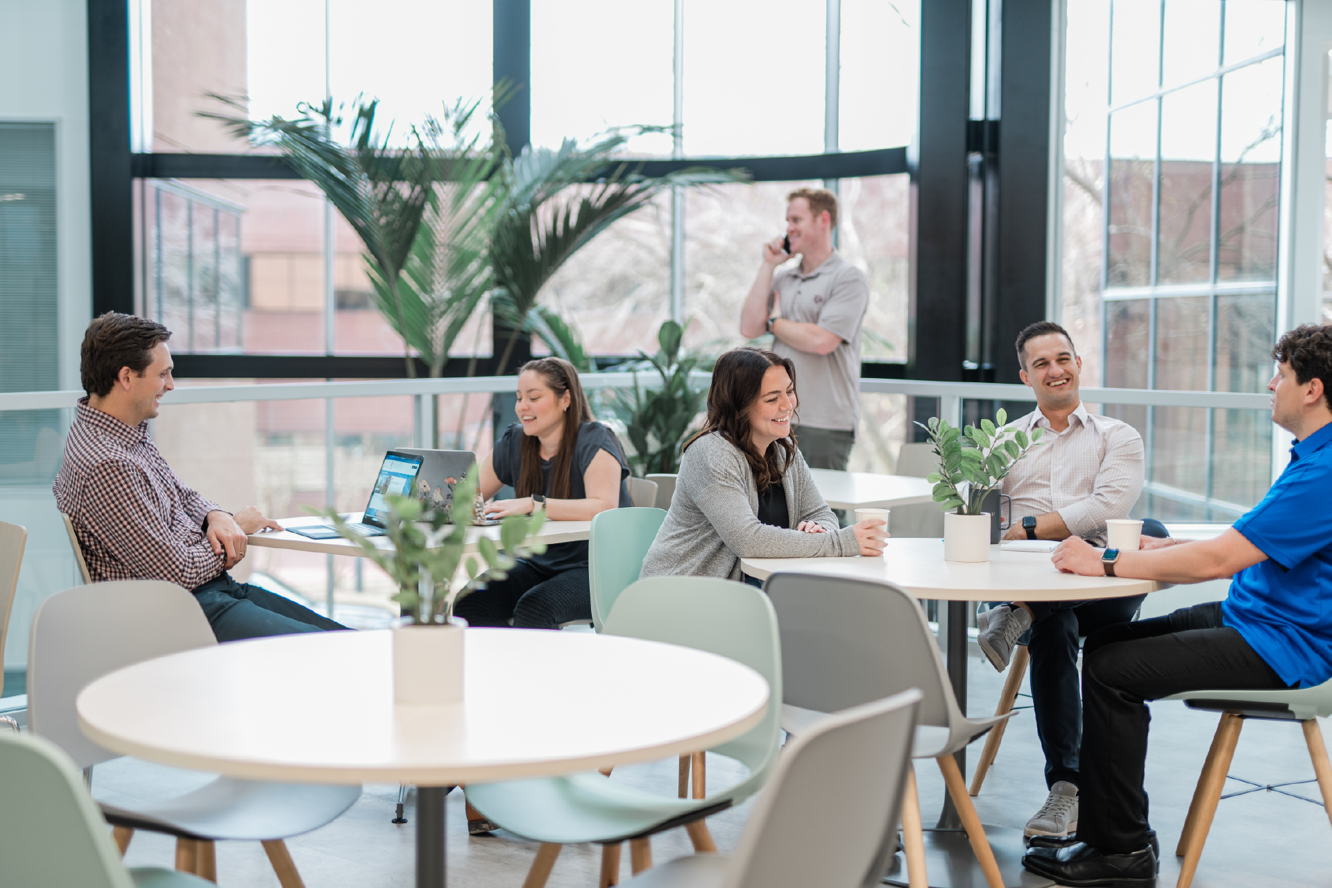 multiple groups of people in a coworking space