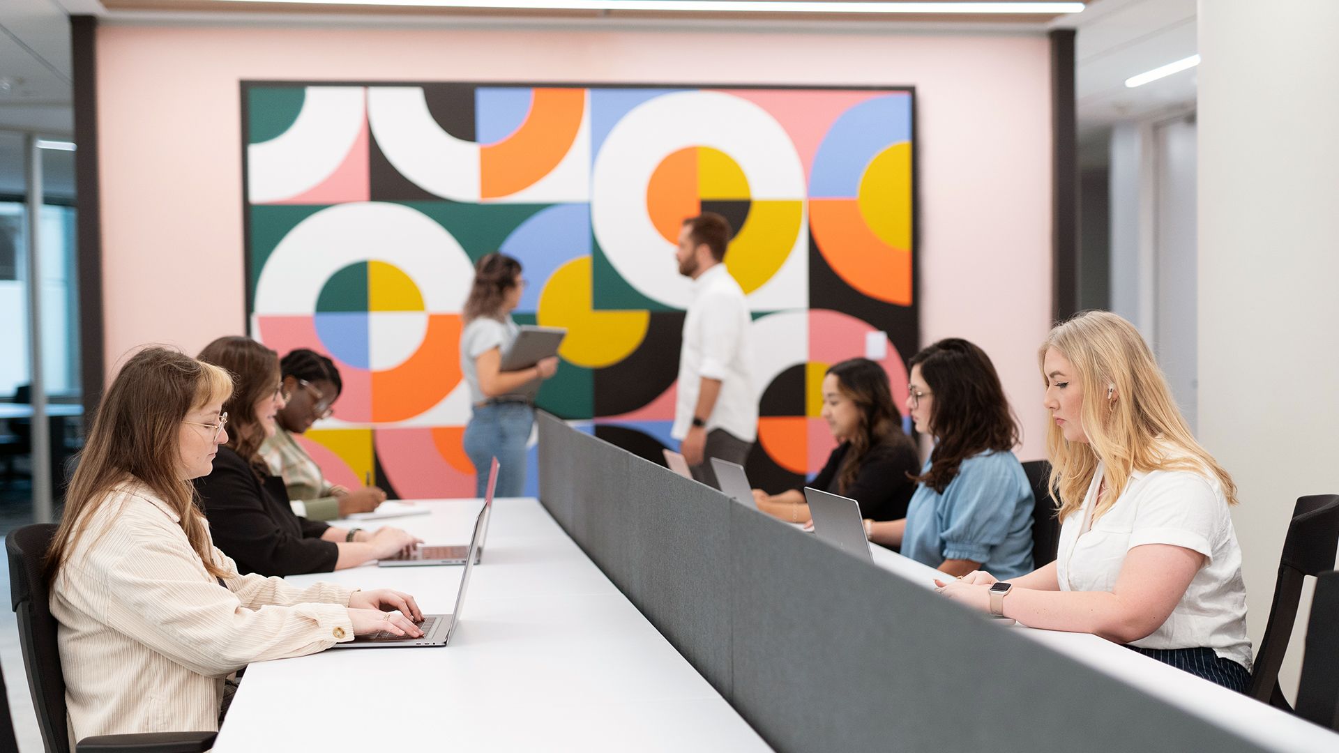 large group of people in a shared office area