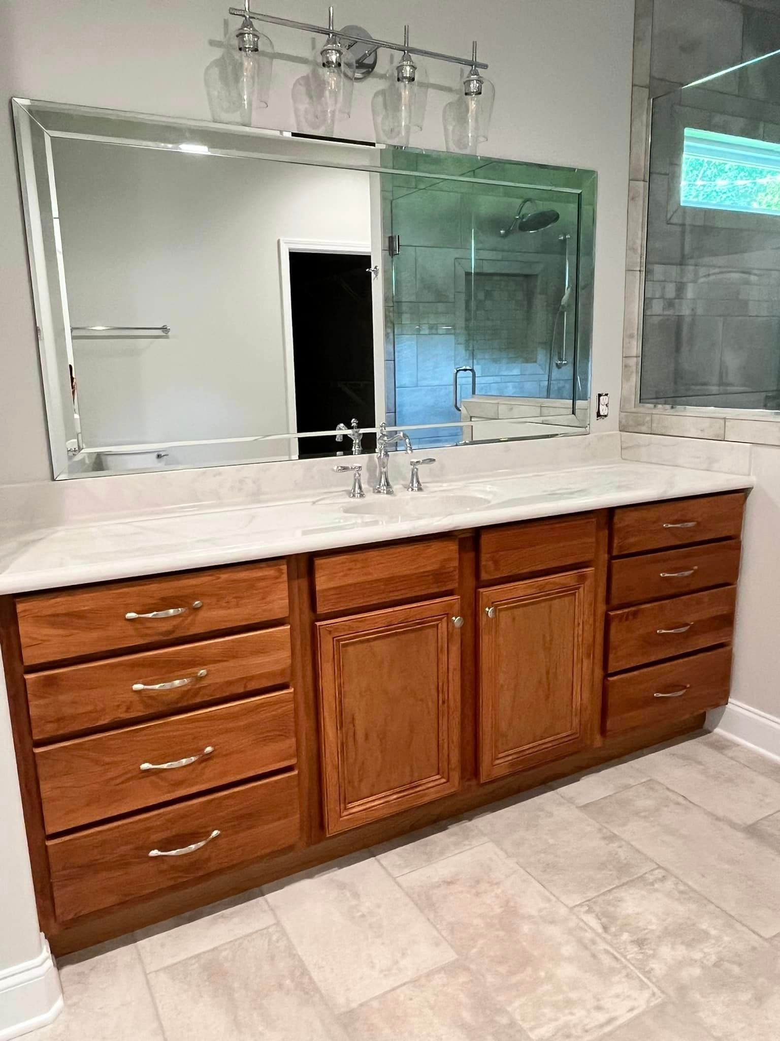A bathroom with two sinks and a large mirror.