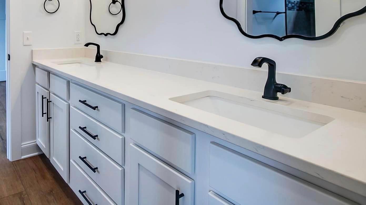 A bathroom with two sinks and two mirrors.