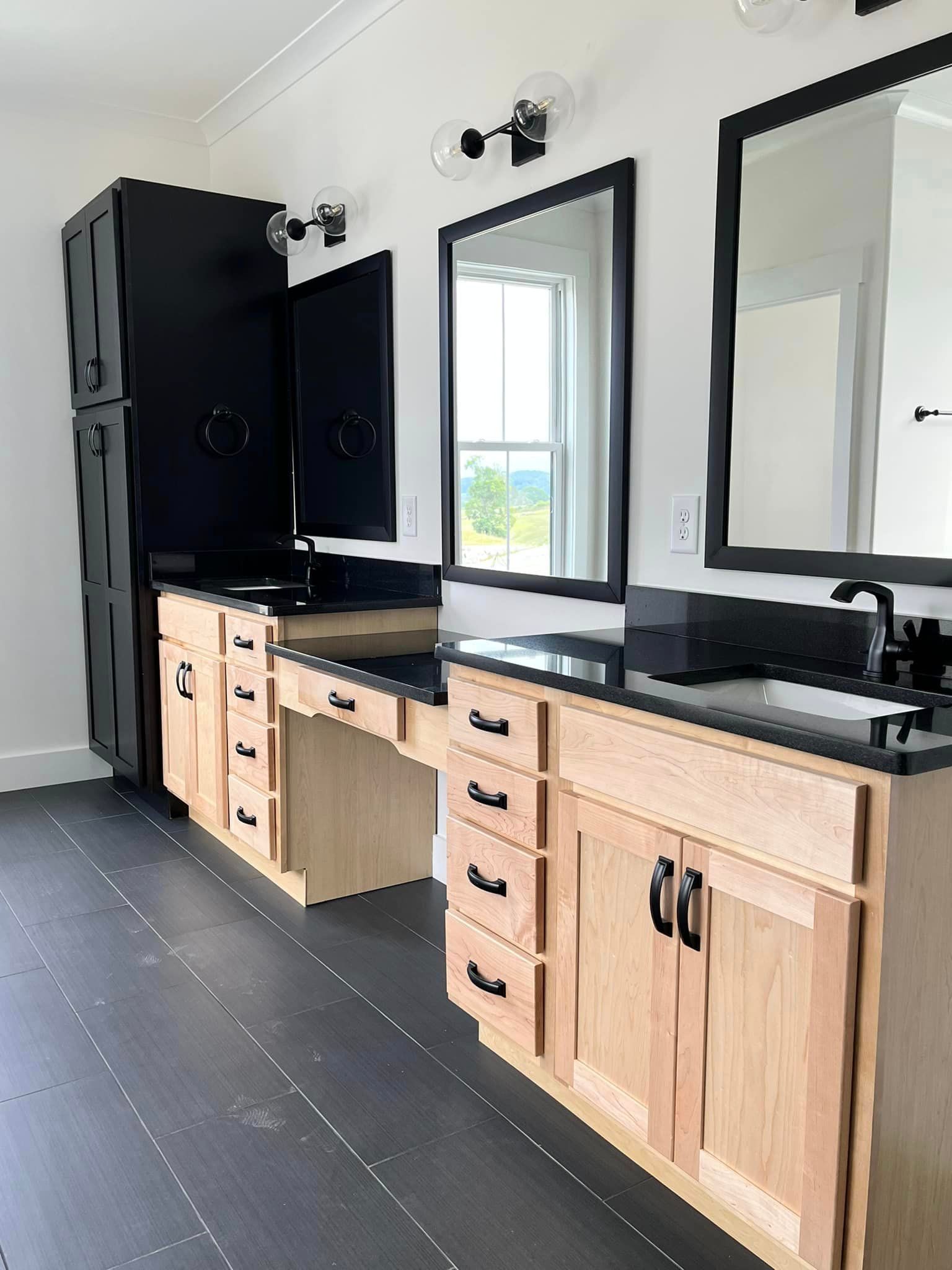A bathroom with two sinks and two mirrors.