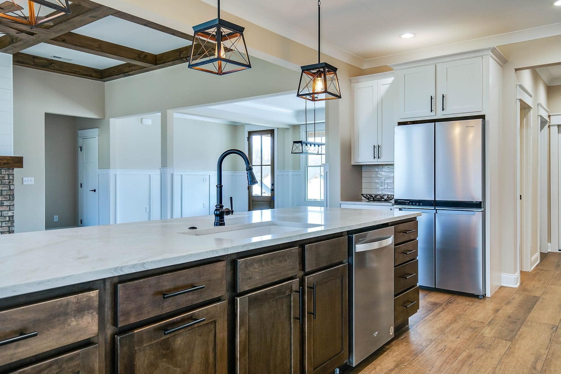 A kitchen with stainless steel appliances and wooden cabinets.