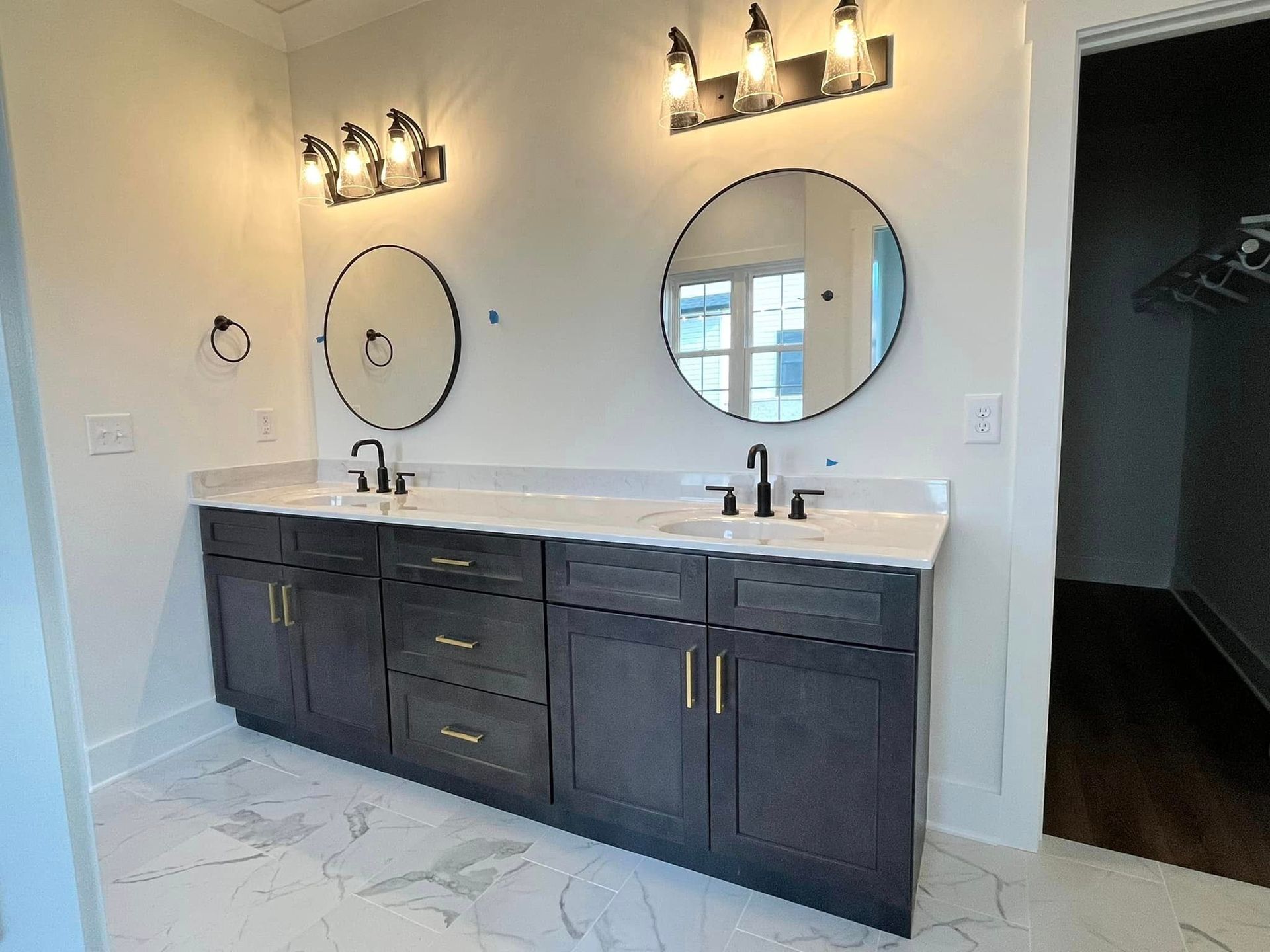 A bathroom with two sinks and two mirrors.