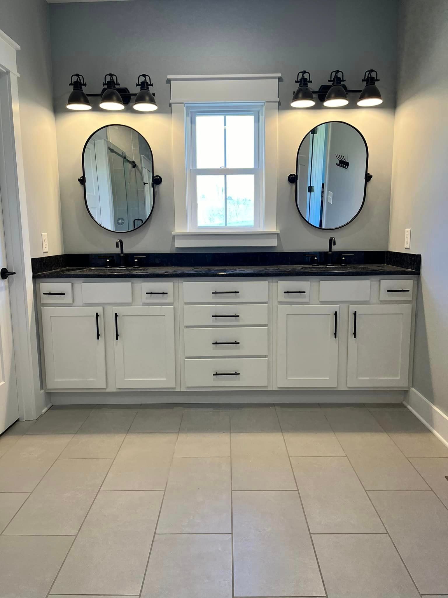 A bathroom with two sinks and two mirrors.