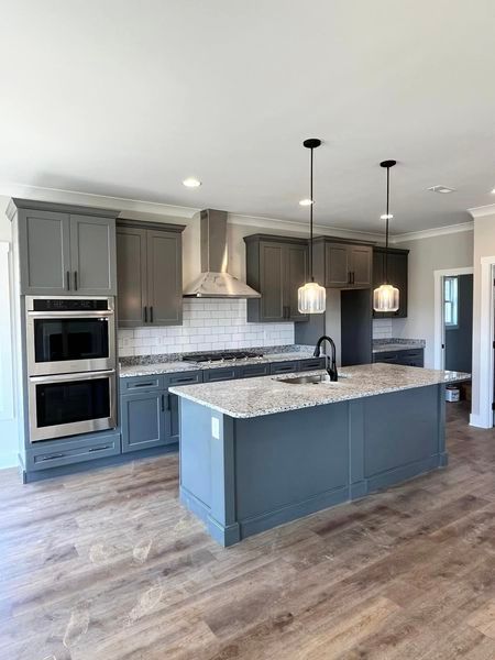 There is a large island in the middle of the kitchen.