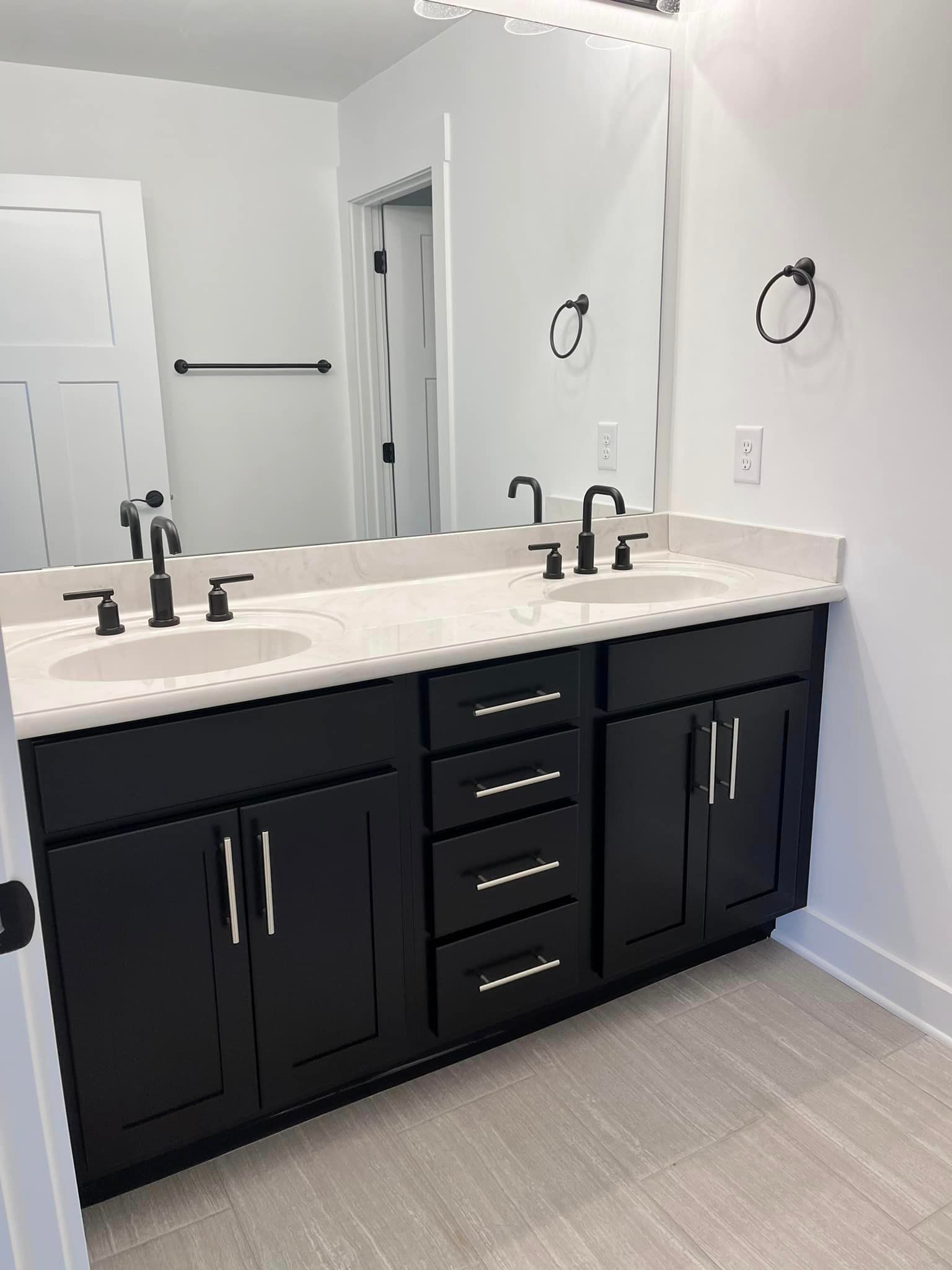 A bathroom with two sinks and a large mirror.