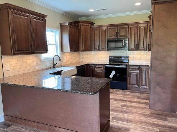 A kitchen with wooden cabinets and granite counter tops
