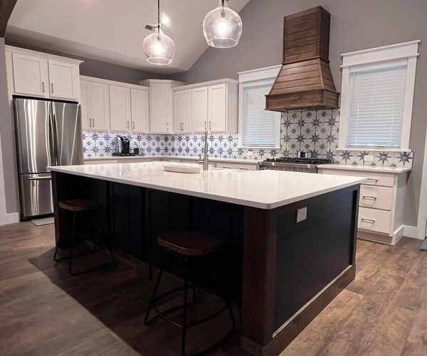 A kitchen with stainless steel appliances and a large island.