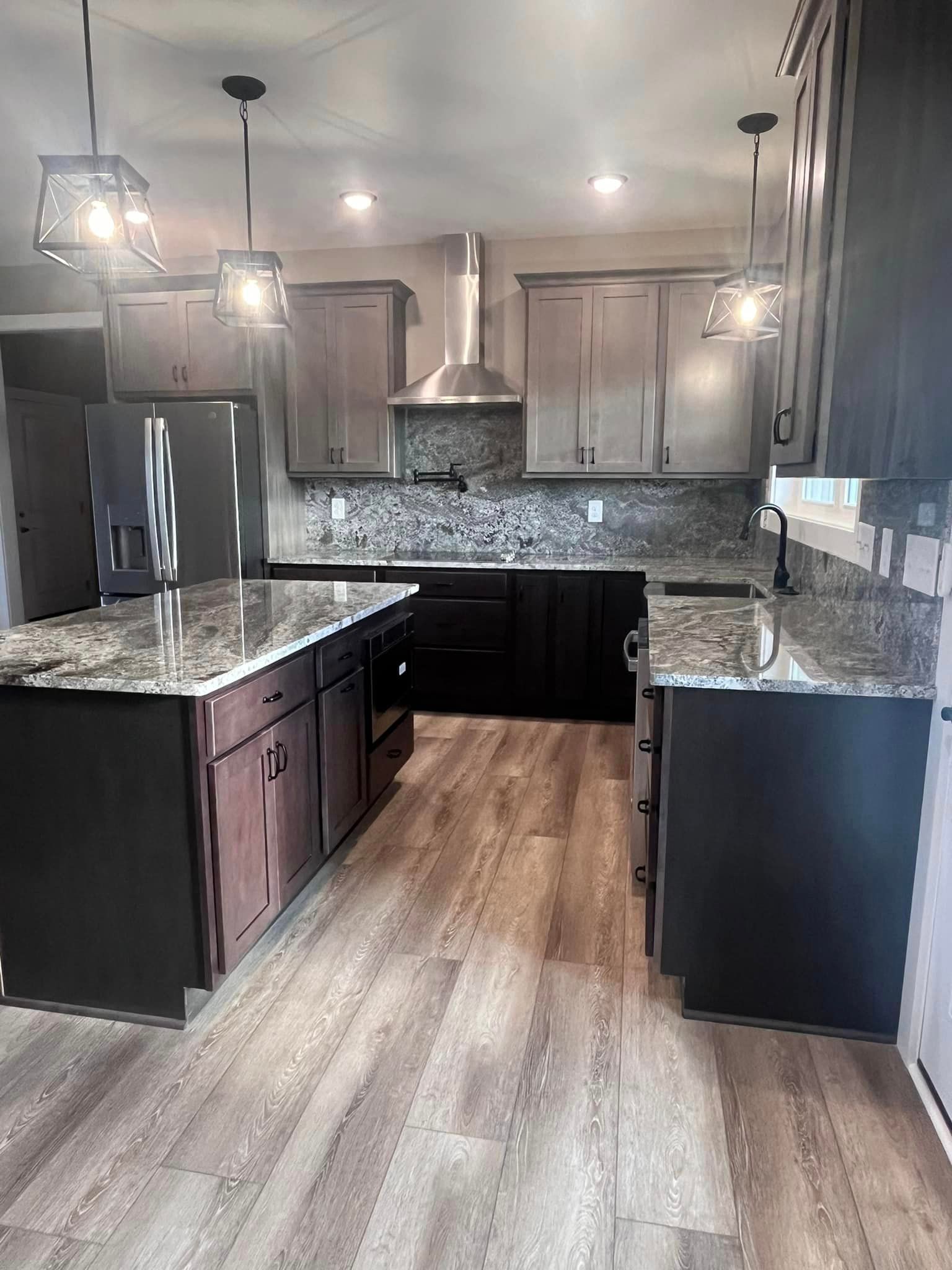 A kitchen with stainless steel appliances and granite counter tops.