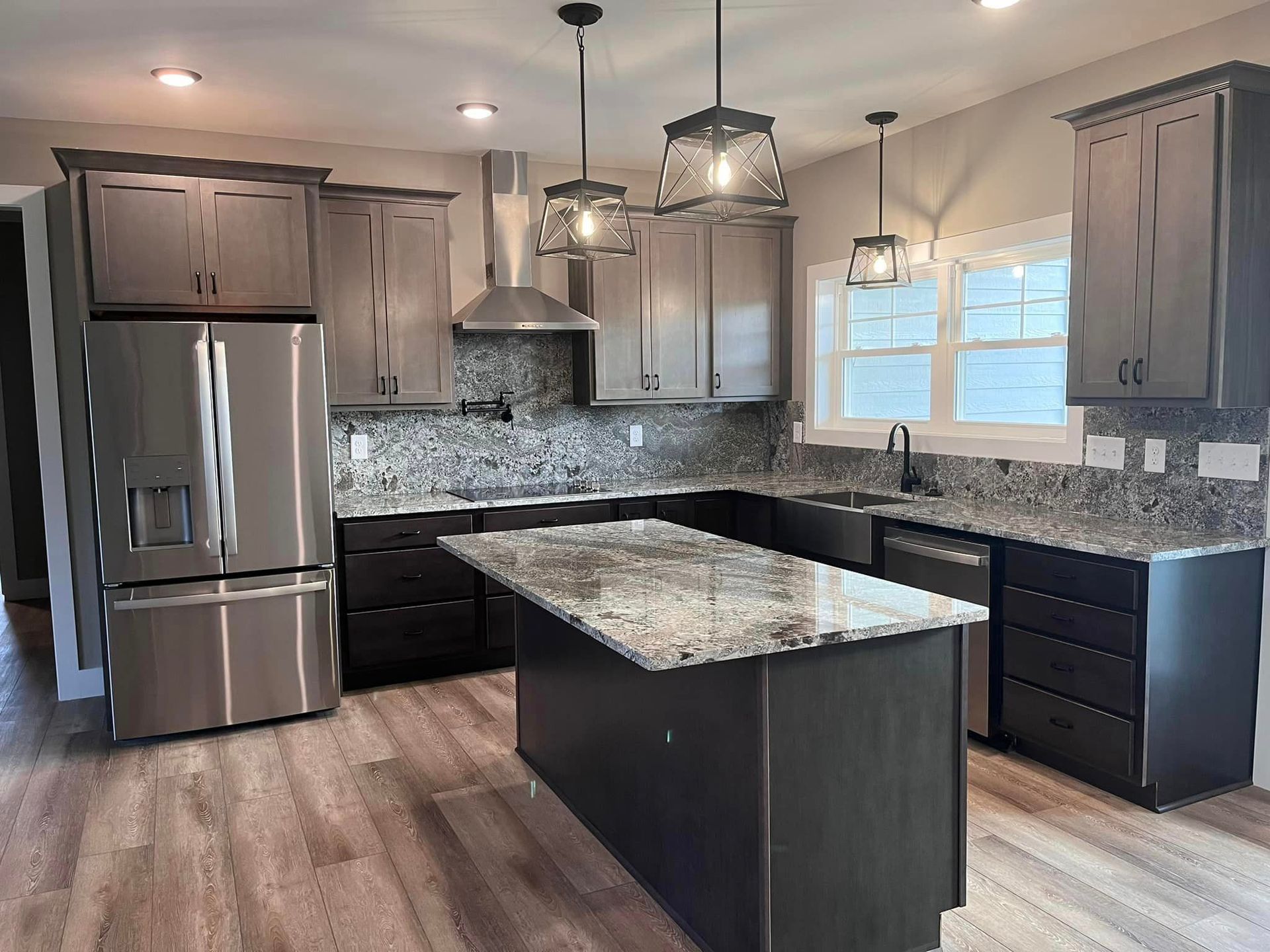 A kitchen with stainless steel appliances and granite counter tops.