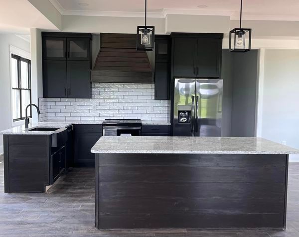 There is a large island in the middle of the kitchen.