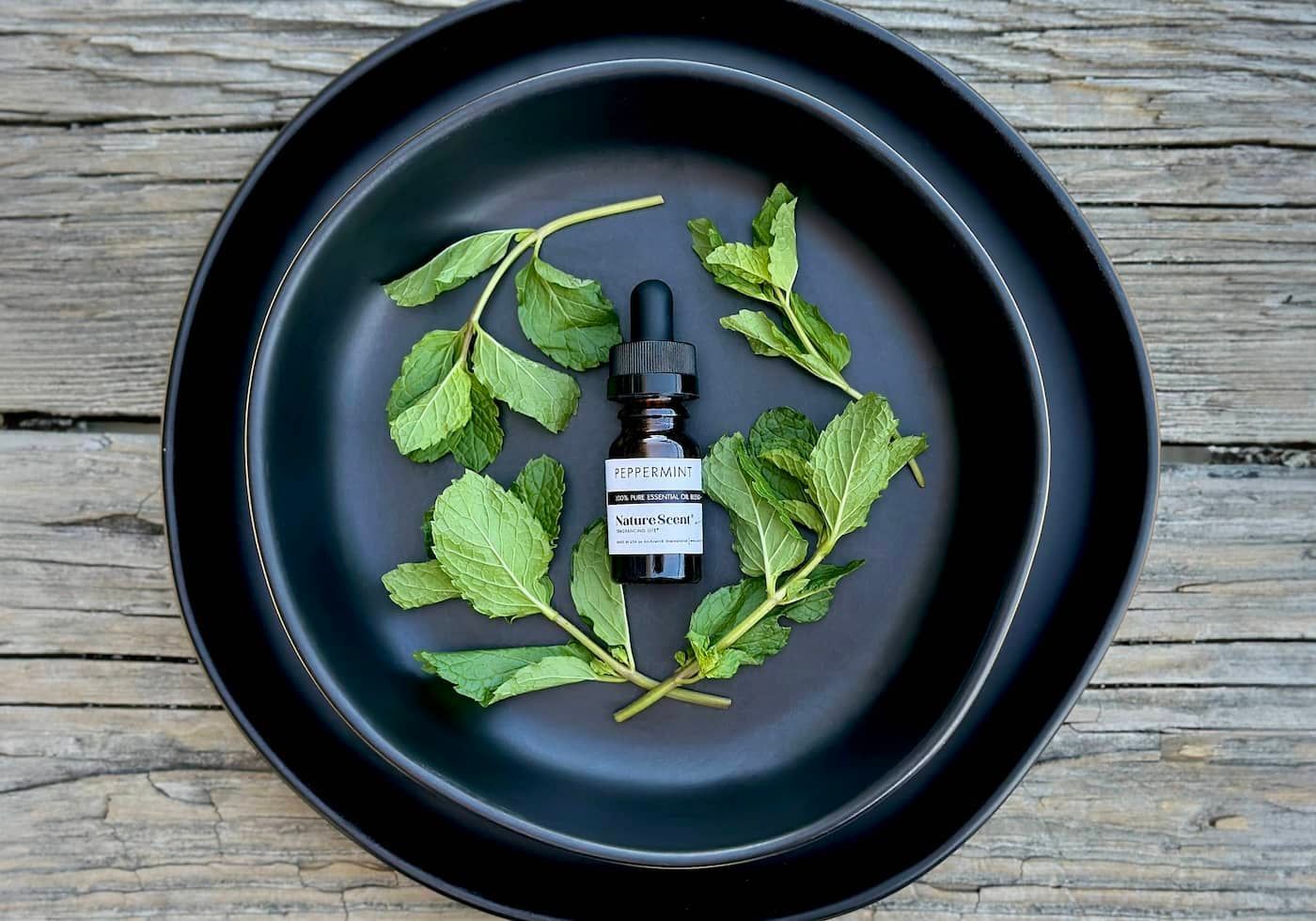 Peppermint Essential oil bottle with peppermint leaves