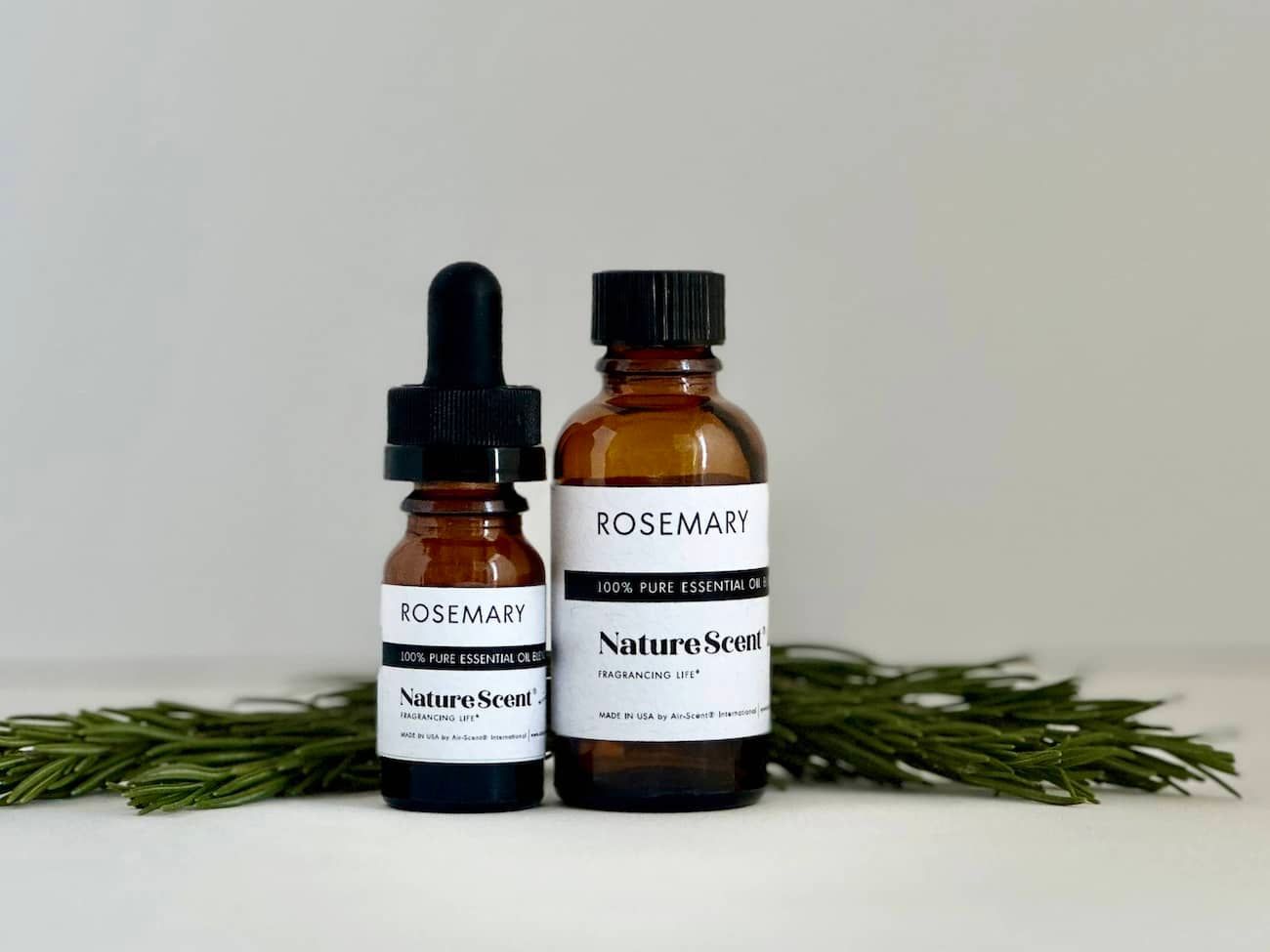 Rosemary Essential oil bottles with rosemary