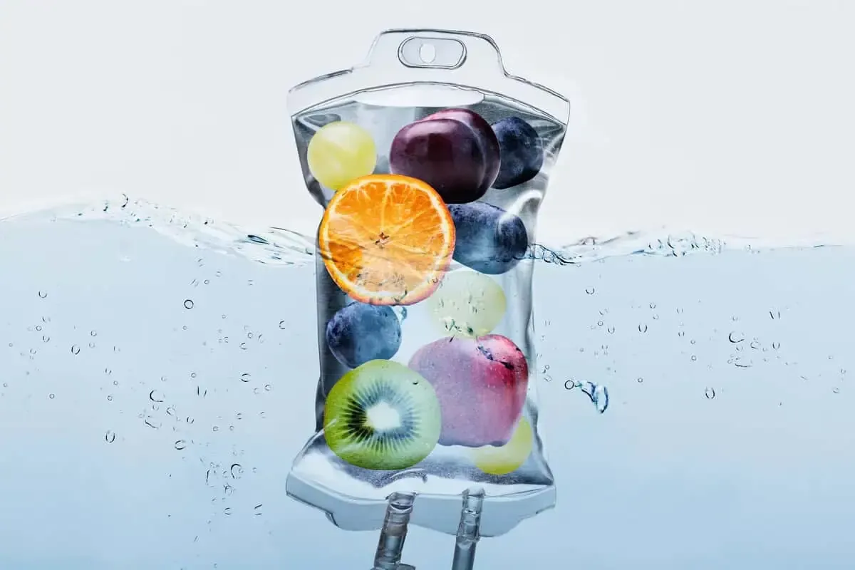 IV bag filled with colorful fruit floating in water.