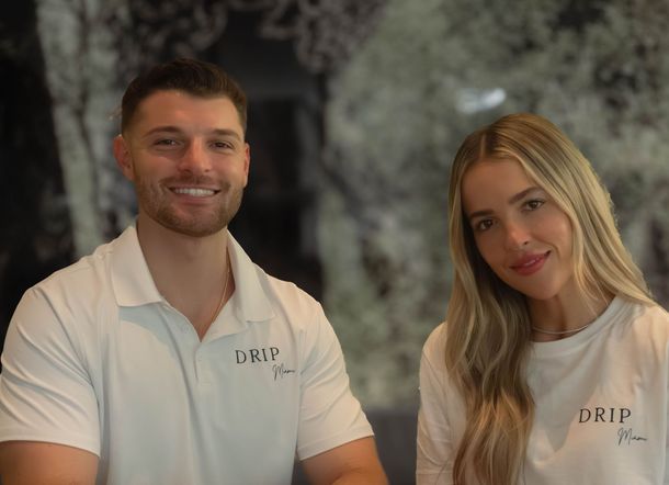 Man and woman in white shirts smiling, logo