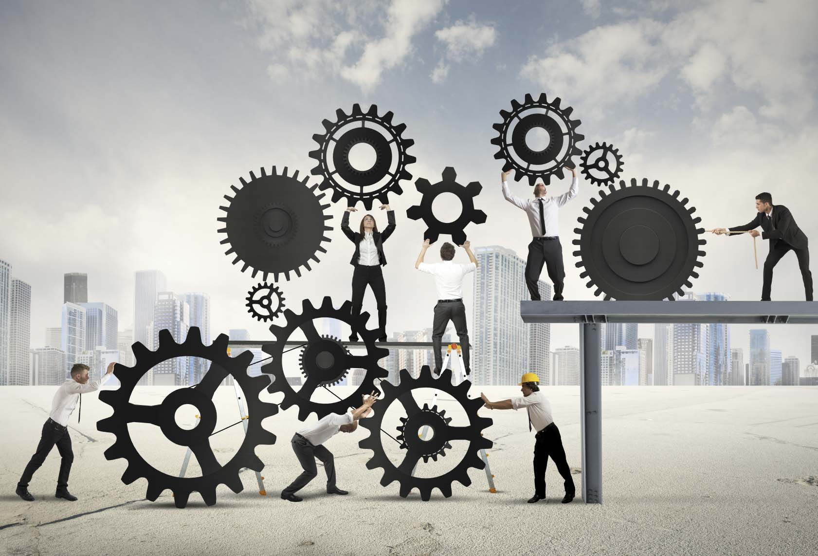 A group of people are working together to build gears