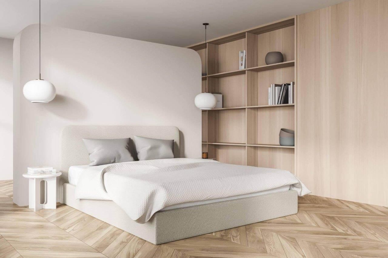 Una camera da letto con un letto, un comodino, degli scaffali e un pavimento in legno.