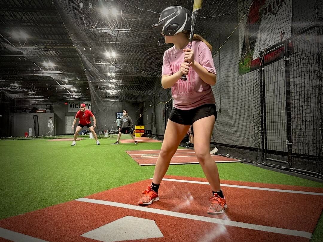 a softball player wearing her visor with the word eagles on it