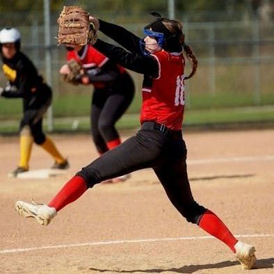 A softball player wearing a red jersey with the number 10 on it