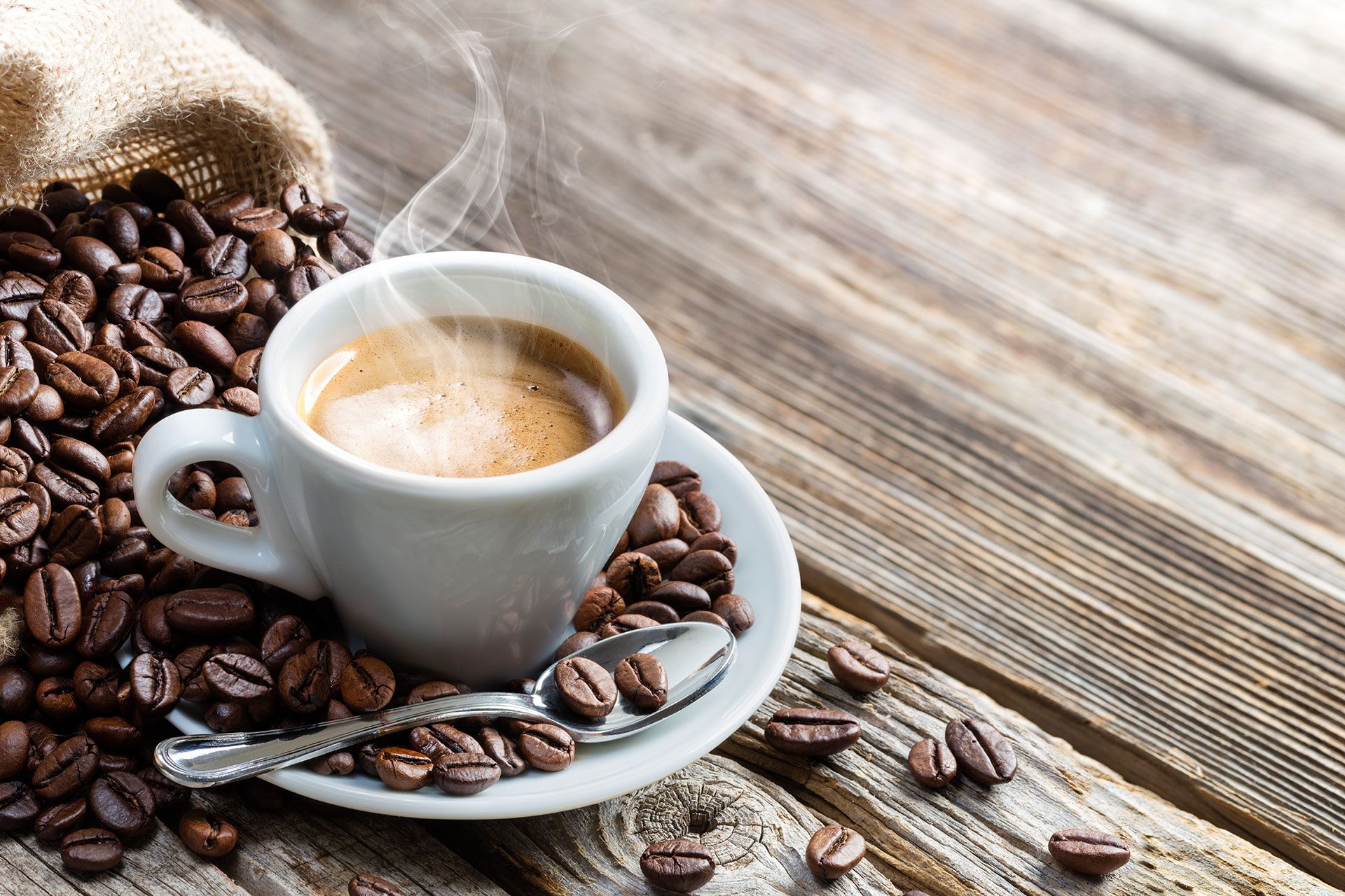 Espresso Coffee Cup With Beans On Vintage Table