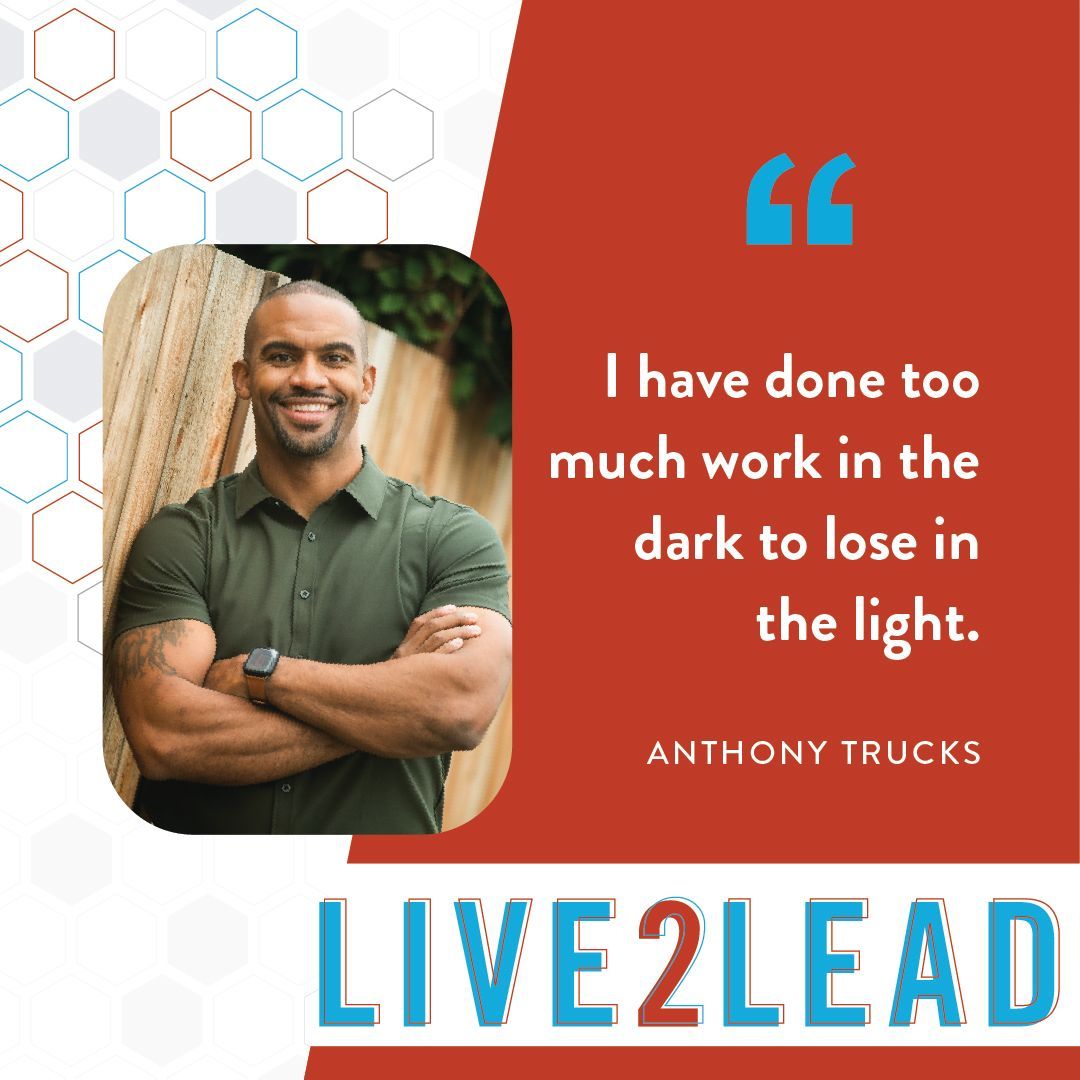 A smiling man with arms crossed next to a quote: "I have done too much work in the dark to lose in the light." LIVE2LEAD.