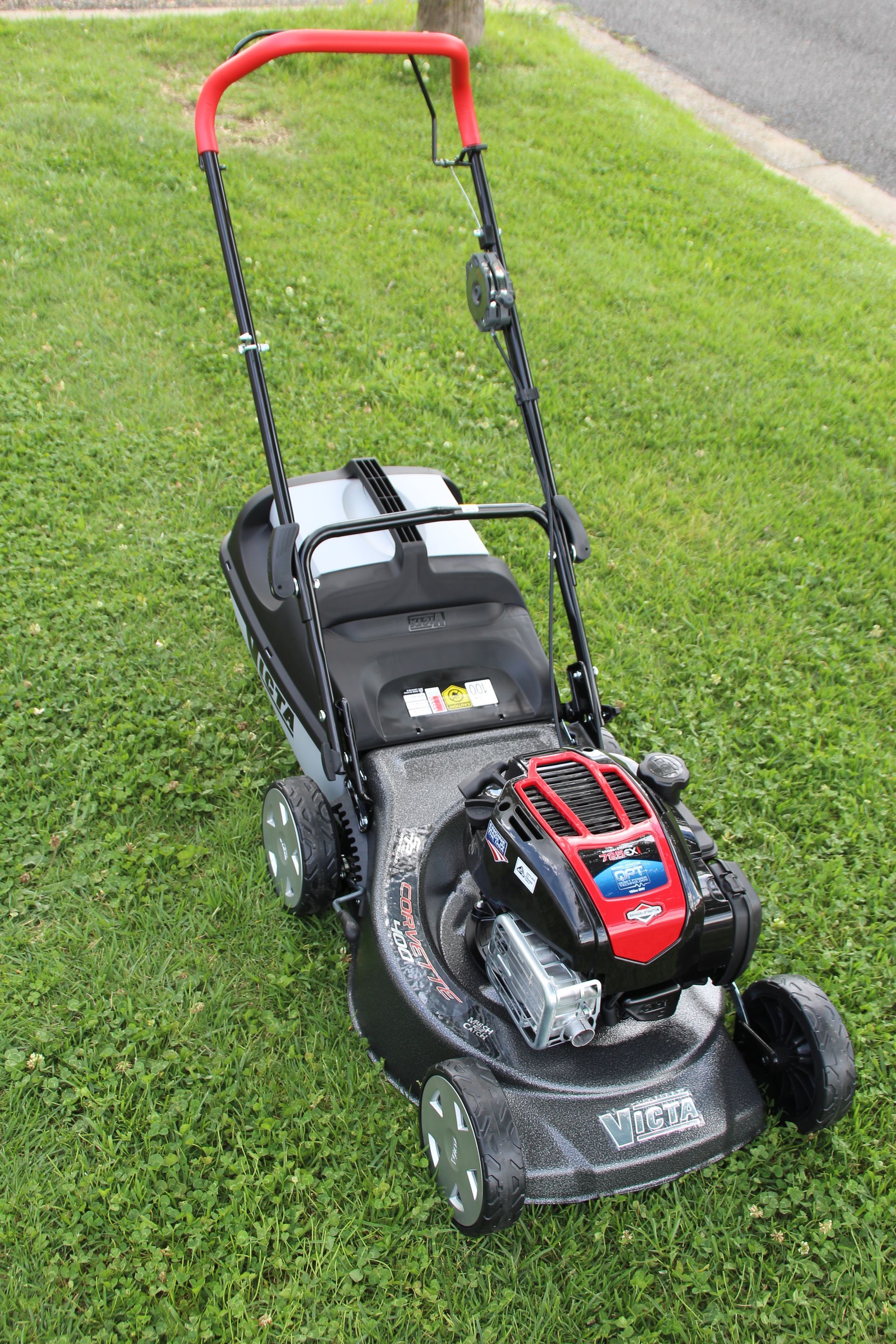 A yellow and black lawn mower on a white background