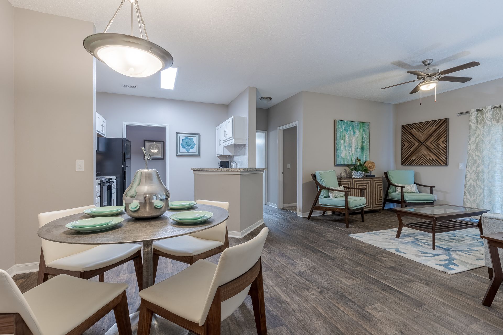 Bedroom with bed, bedside tables, lamps, and closet. Gray and white color scheme, neutral tones.