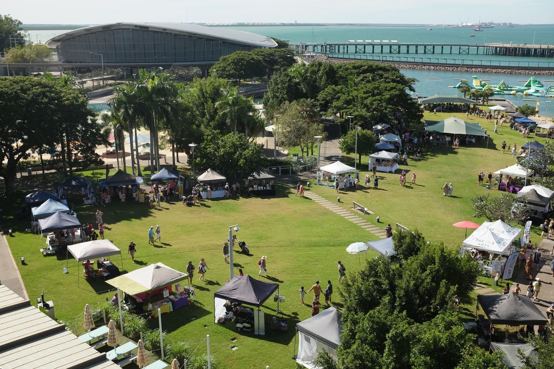 Boy sliding across a blue water slide.