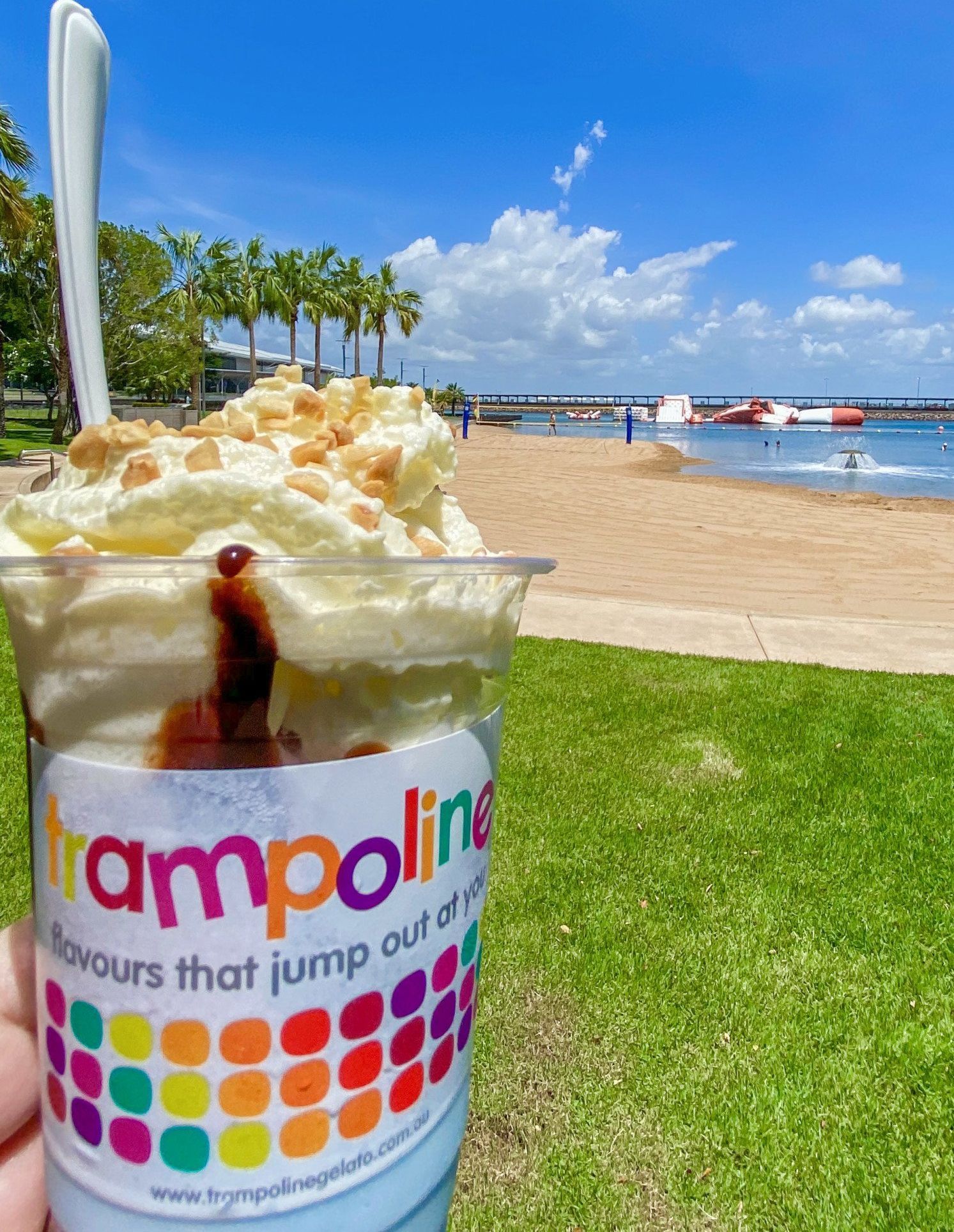 Cup of ice cream with a beach backdrop.