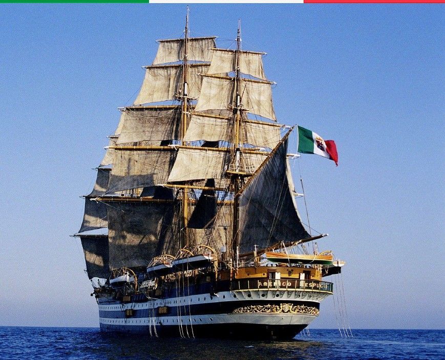 Tall ship sailing on a blue sea under a clear sky; flying a Mexican flag.