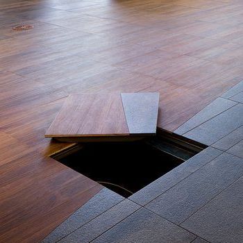 A wooden floor with a hole in the middle of it.