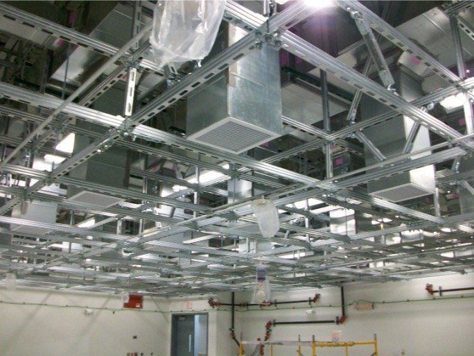 A ceiling with a lot of ducts hanging from it