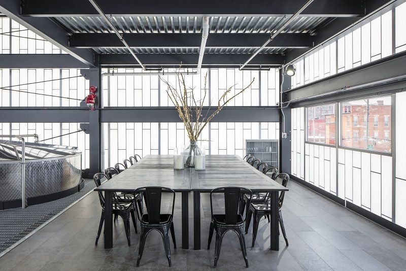 There is a table and chairs in the middle of the room.