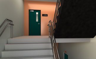 A staircase leading up to a green door in a building.