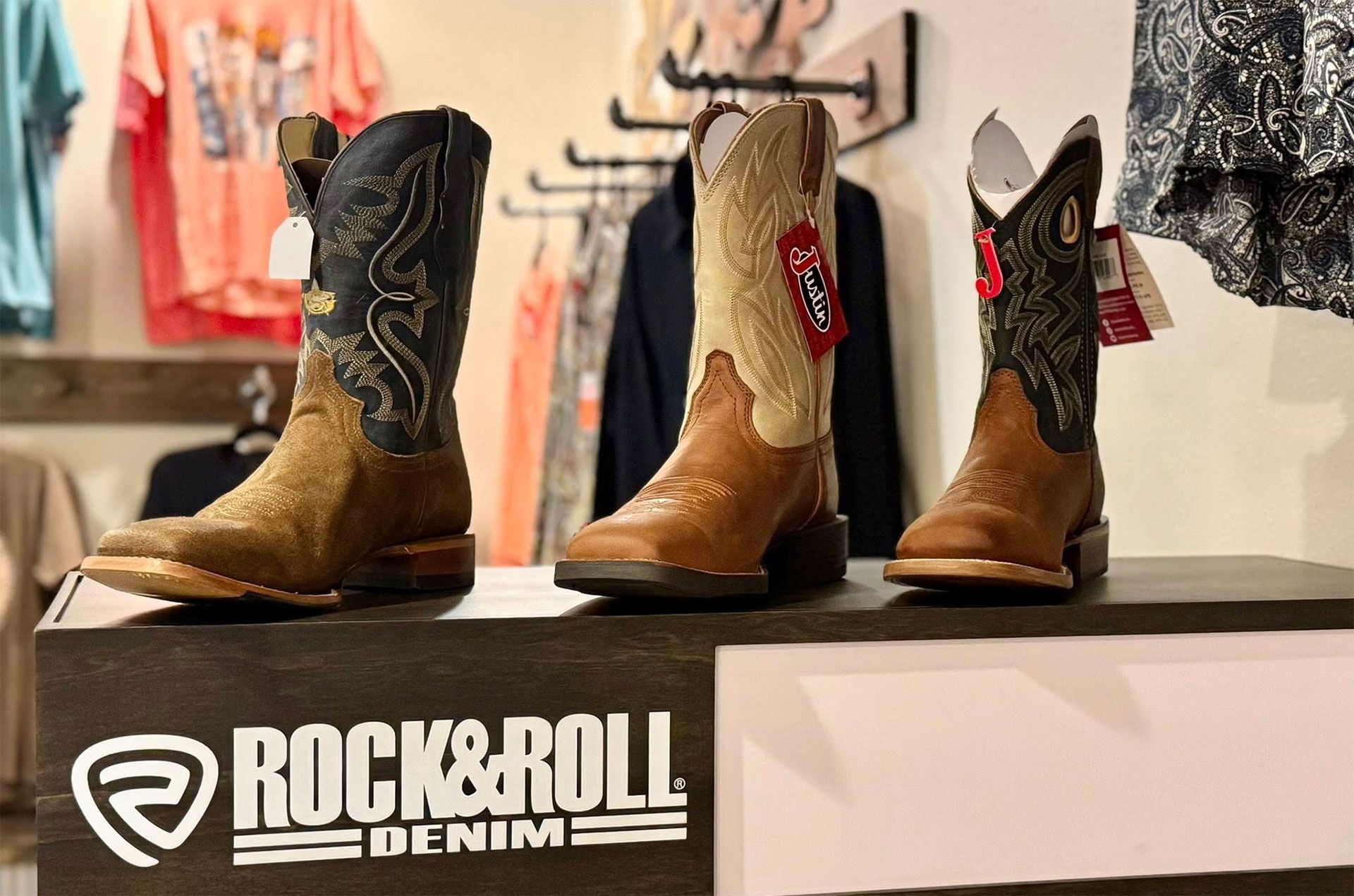 Three cowboy boots displayed in a store 