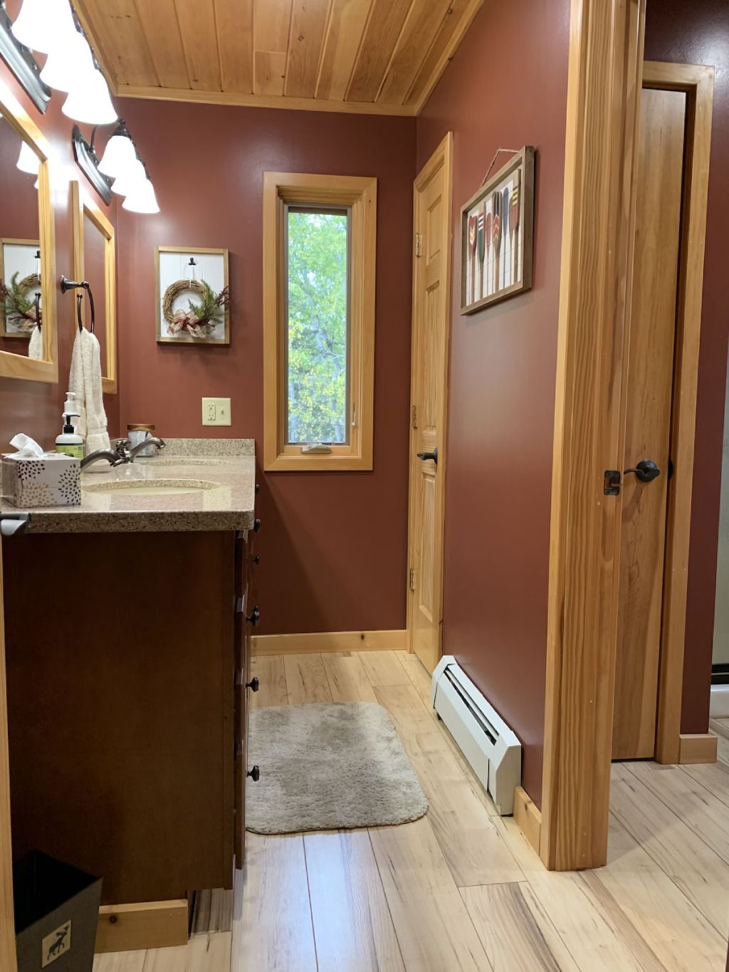 A bathroom with two sinks and a window