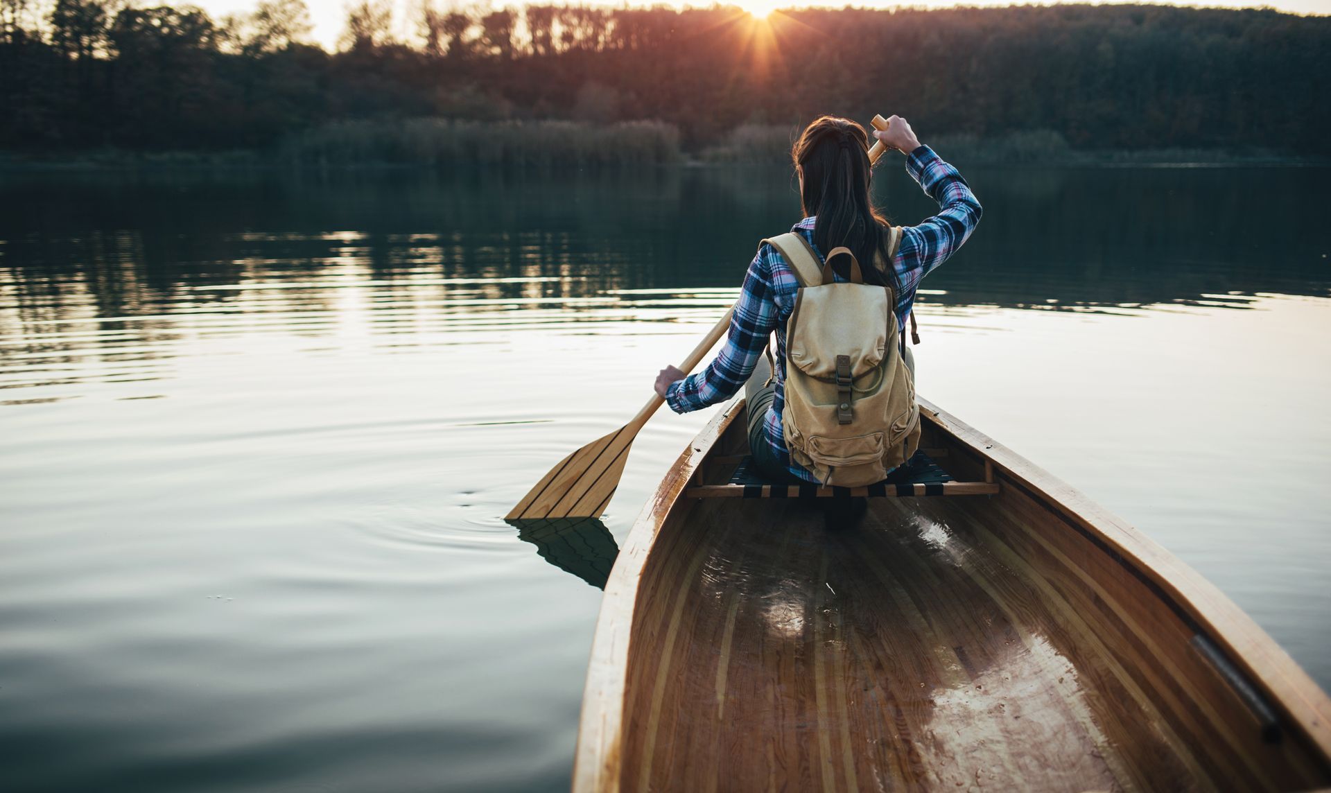 A wooden bridge leading to a cave in the woods.