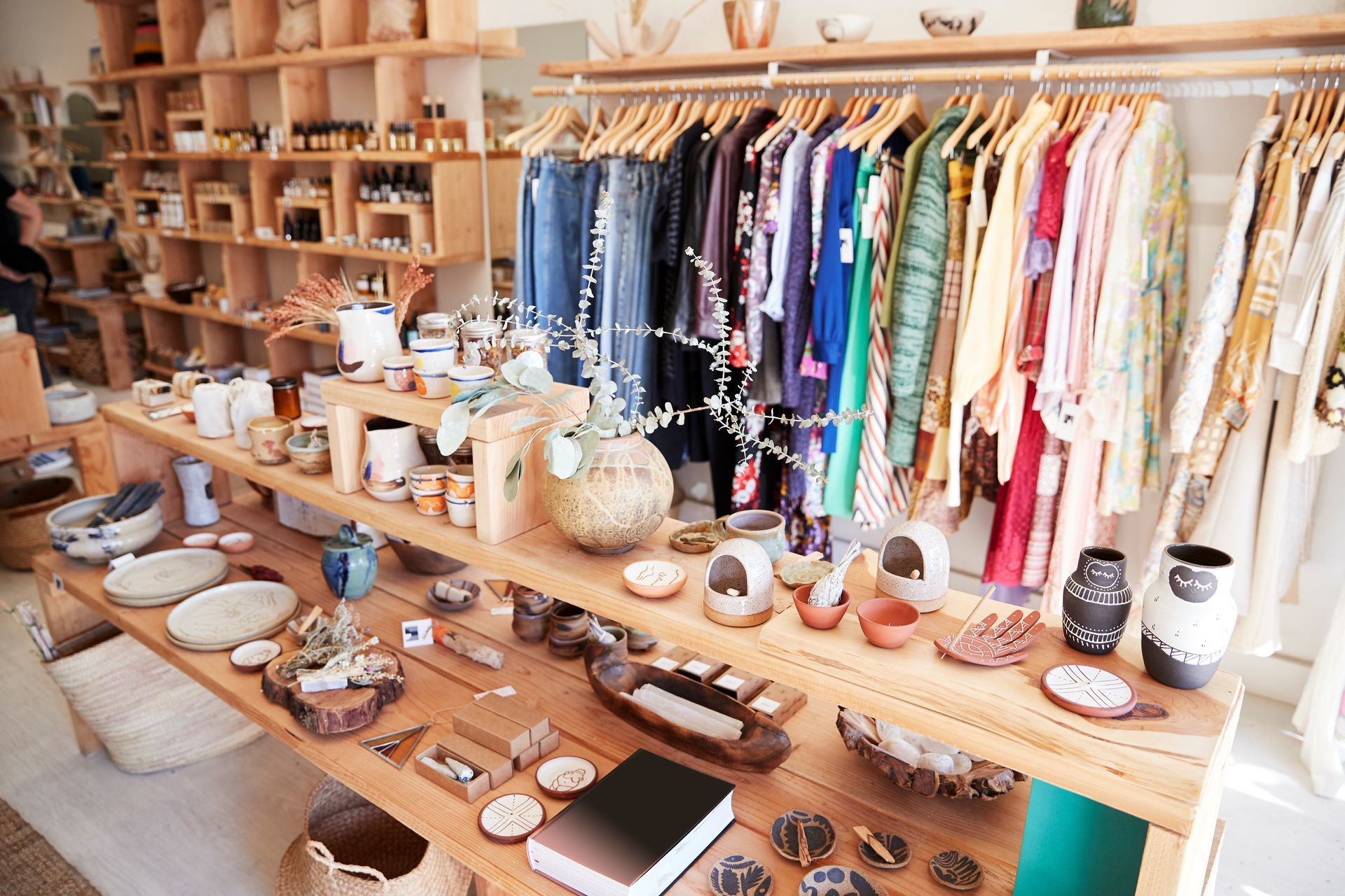 A store filled with clothes , vases , and other items.