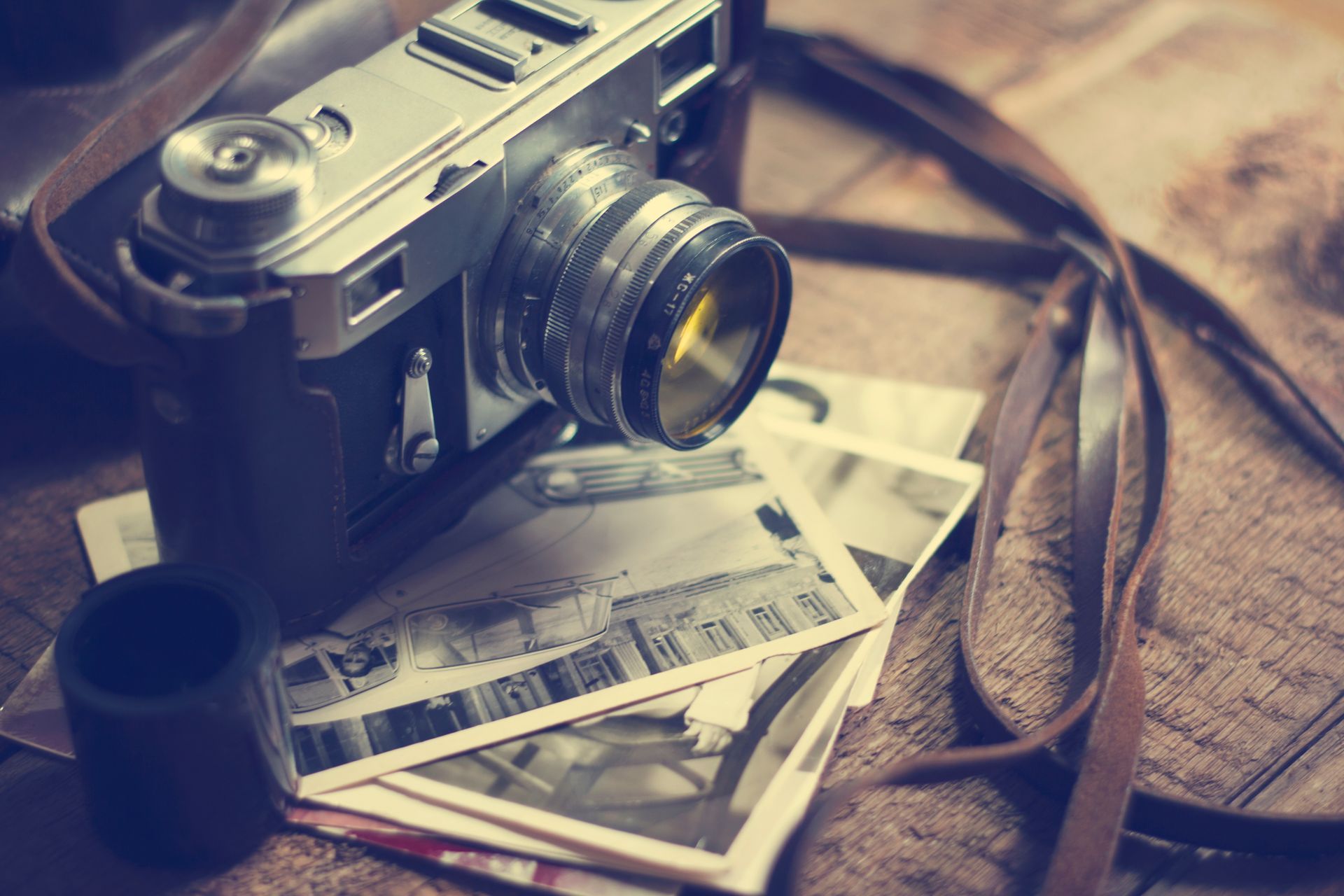 A wooden bridge leading to a cave in the woods.