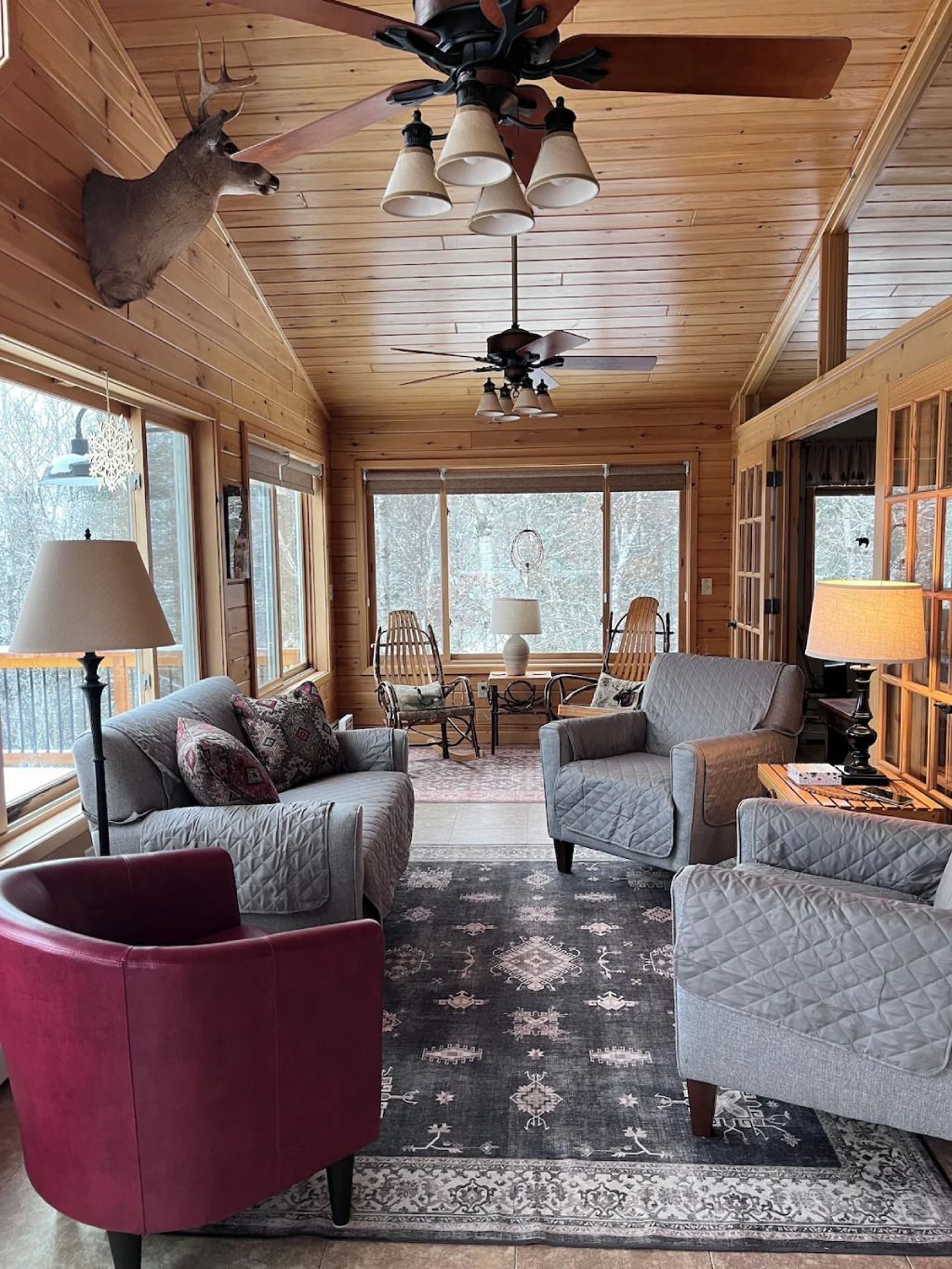A living room filled with furniture and a ceiling fan.