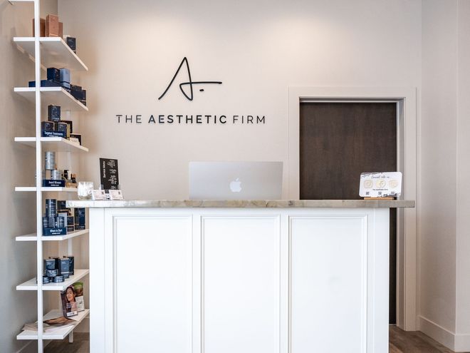 the front desk of the aesthetic firm with a laptop on it