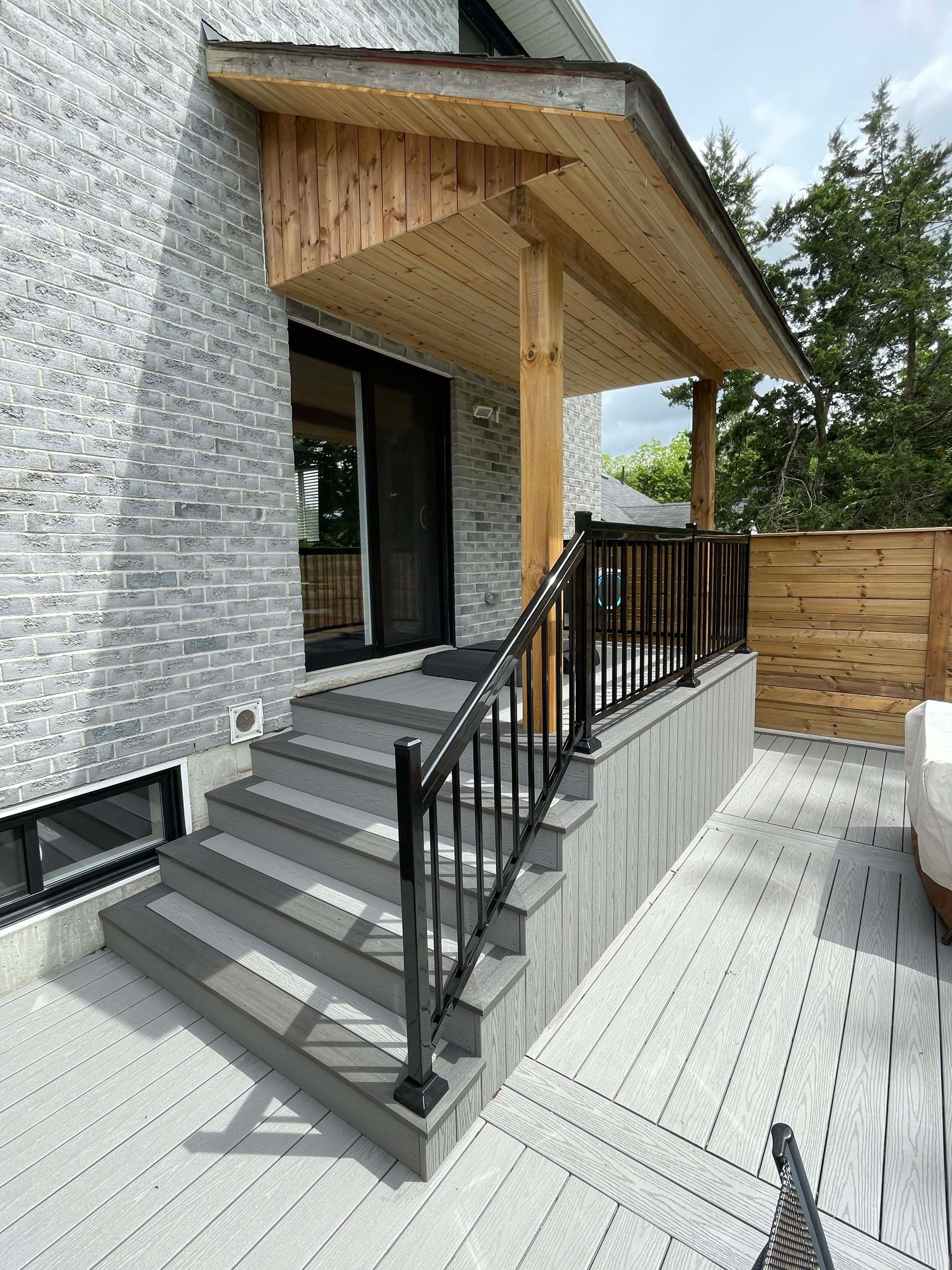 A house with a porch and stairs leading up to it.