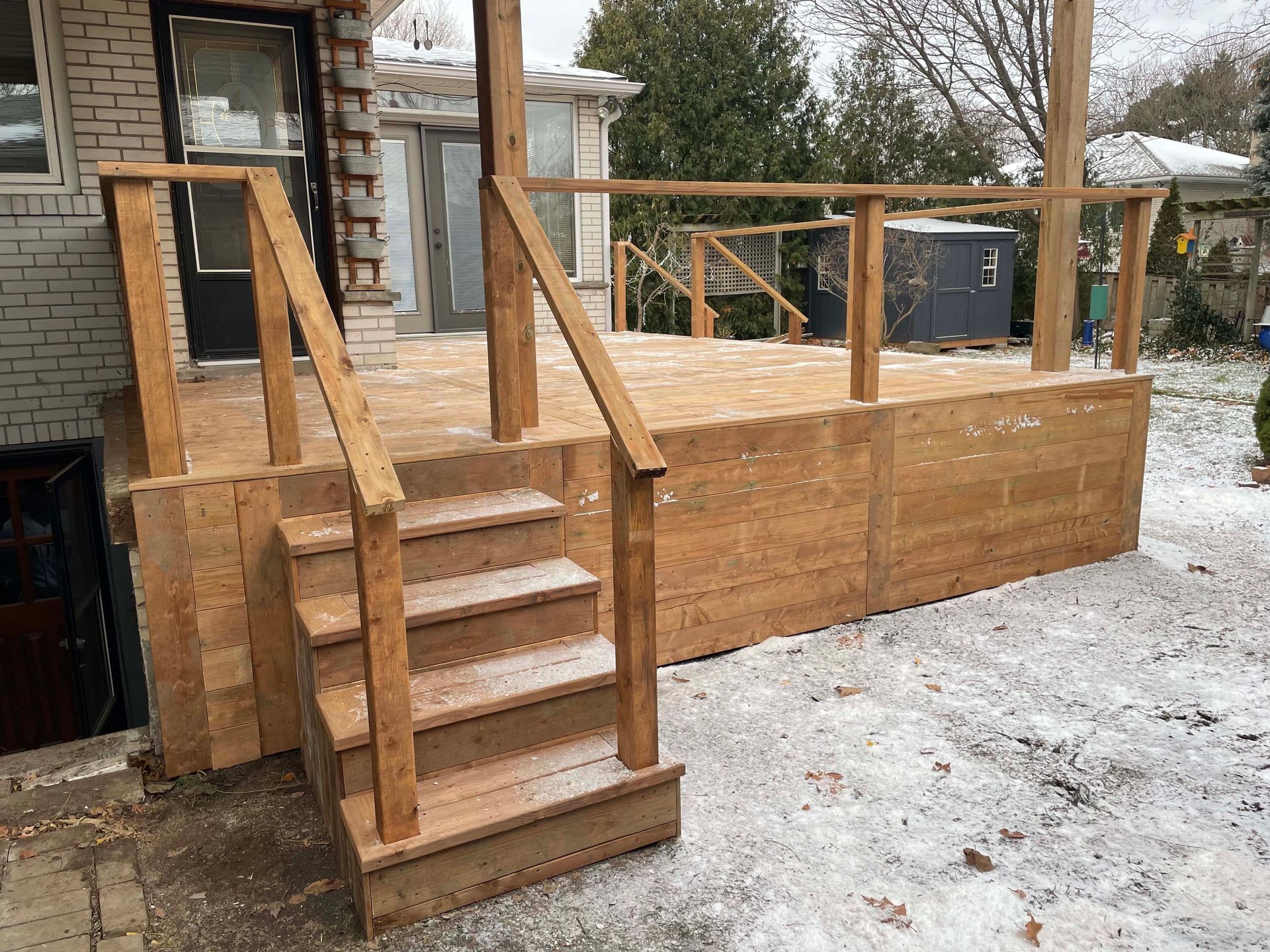 A wooden deck with stairs leading up to it